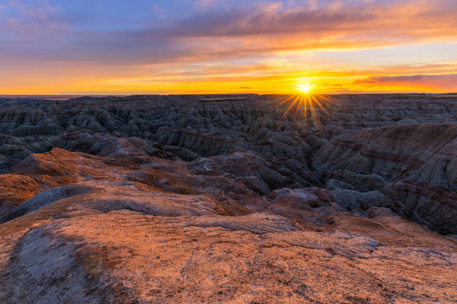 Sunset over eroded ridges of the northern plains badlands