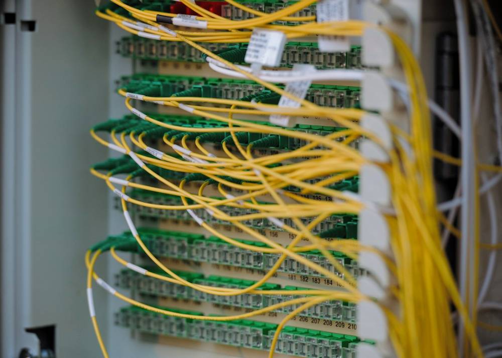 Fiber optic cables patched into a network panel