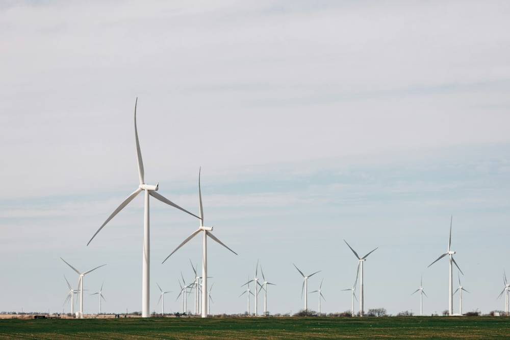 A line of wind turbines across flat open country